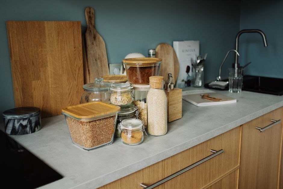 A tidy kitchen counter with jars and everyday ingredients arranged for practical use.